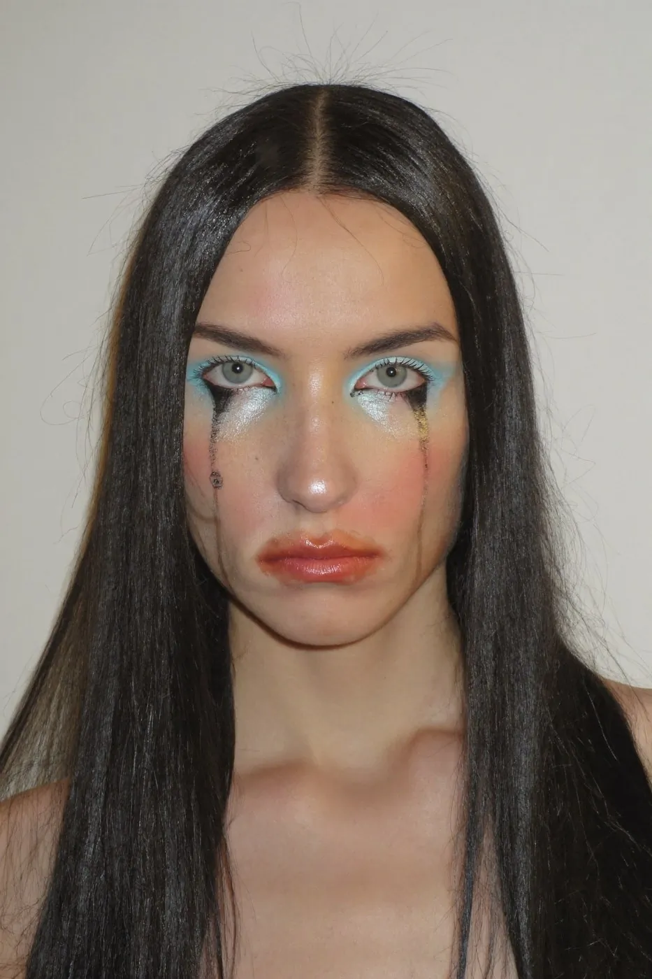 AI beauty image with cyan eyeshadow bled around the eye and liner run into tears
