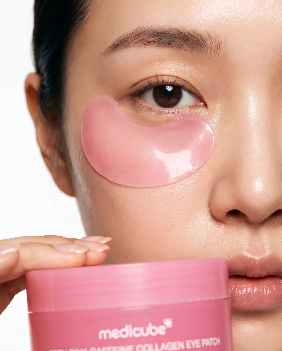 Pink eye patches worn on skin with the jar held below